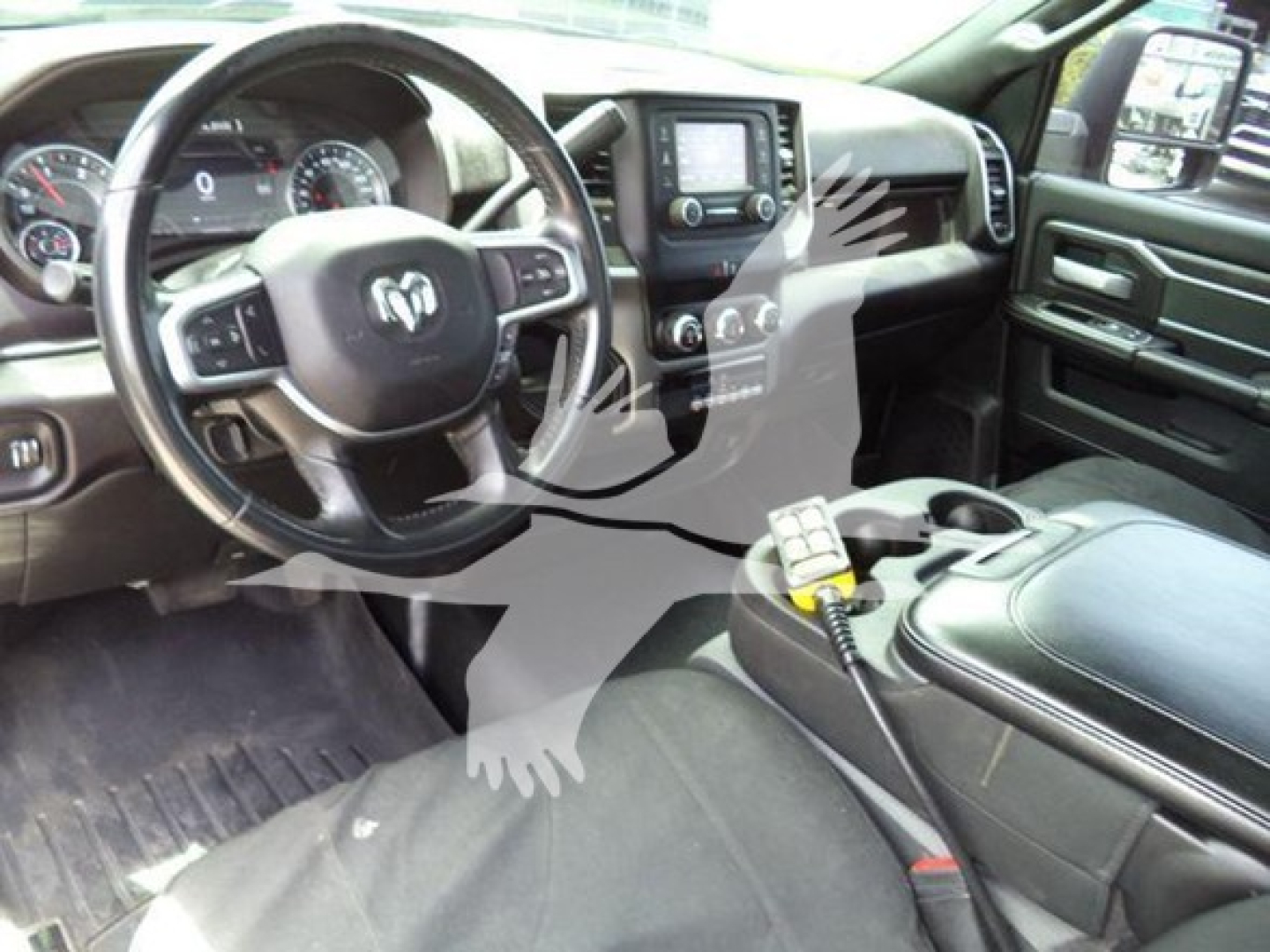 Ram 4500 interior showing steering wheel and center console with navigation screen and a radio mic on the console.