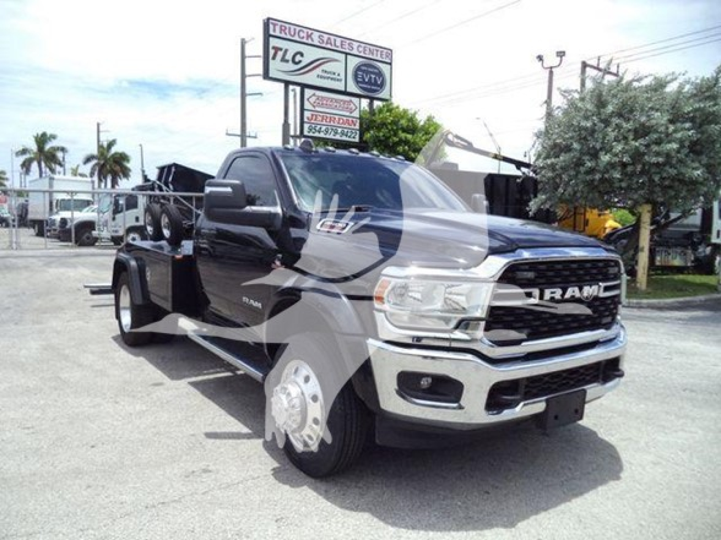 Ram 4500 SLT pickup truck in a dealership lot showing front and side profile with large dual rear wheels and winch equipment