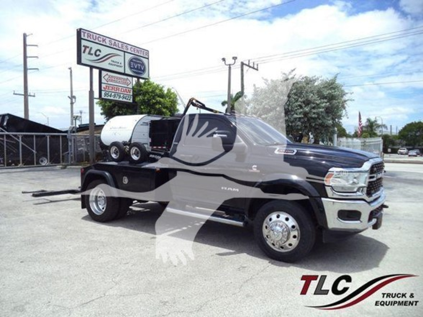 Ram 4500 pickup with winch, front cab, black and gray color, TLC watermark, dealership sign in background. Vehicle shows Ram badge on door.