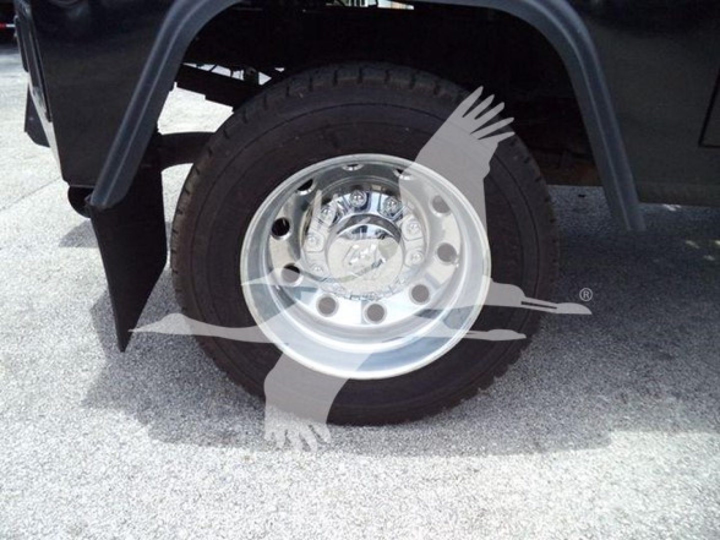 Ram 4500 wheel and tire visible under fender, chrome hubcap with circular holes and lug nuts; winch category vehicle appears in the listing.