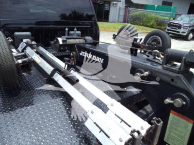 Ram 4500 truck chassis with winch assembly showing Jerr-Dan equipment and metal ramps on diamond plate bed.