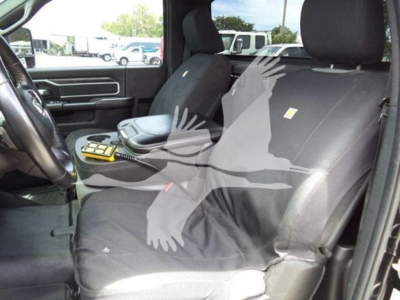 Ram 4500 SLT interior showing front seats and center console with seat covers and scattered items.