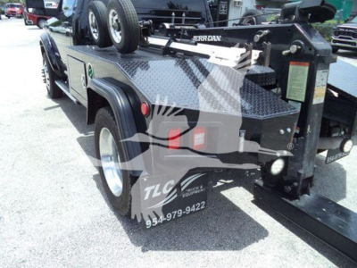 Ram 4500 SLT winch truck bed with diamond plate toolbox, dual rear wheels, and front-mounted hitch assembly visible.