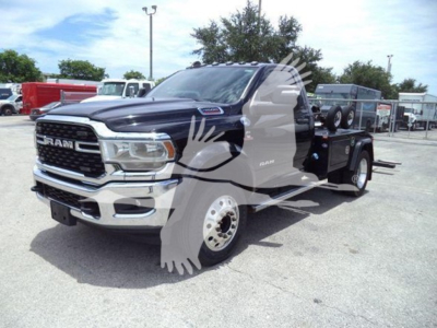 Ram 4500 pickup tow truck in a dealership lot showing front grille and extendable boom winch.