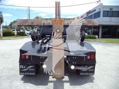 Ram 4500 tow truck rear with mounted winch system and hitch, dual rear lights, black bumper, and rust-colored metal hitch arm.
