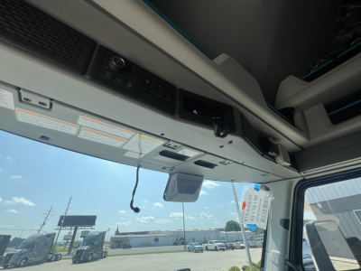Cab interior view of a 2026 Volvo VNL64T860 showcase module panel and overhead controls visible from the sleeper cab.
