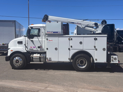 Truck body showing utility service truck with crane mounted on bed, white cab, multiple compartments, and boom crane extended.