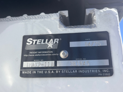 Stellar Industries label plate on a vehicle component showing model TMX??-? and serial number 381945 with date 04/23. The plate reads MADE IN THE U.S.A. BY STELLAR INDUSTRIES, INC. and shows patent info URL www.stellarindustries.com/ip.