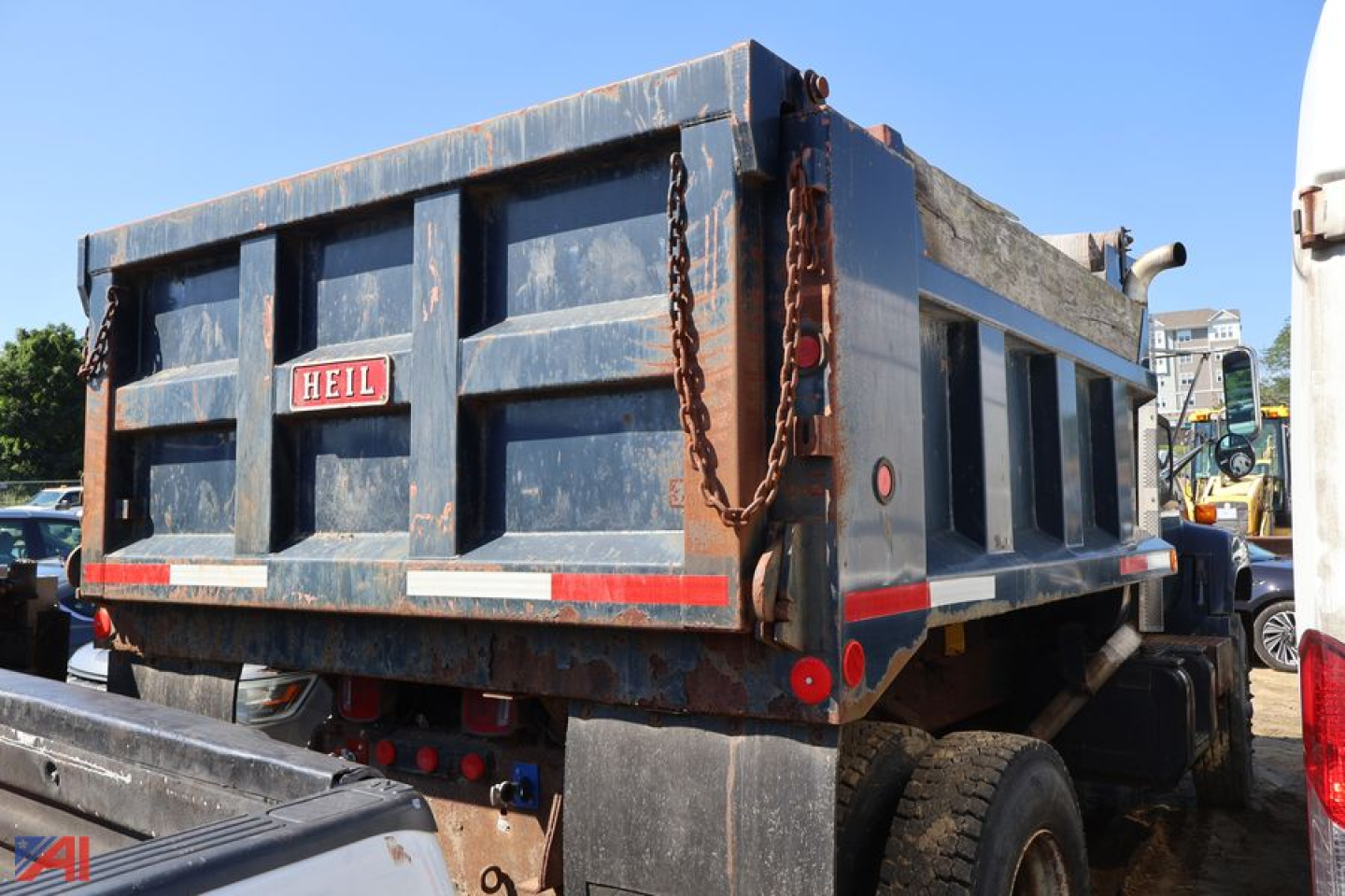 Dump truck bed of a 1996 Chevrolet Kodiak C7500 showing rear with HEIL dump body and chain hooks.