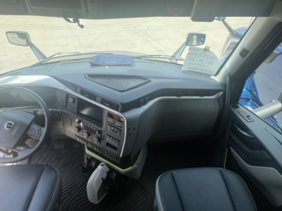 Volvo VNL64T660 truck cab interior showing steering wheel, dashboard with controls, center console, and gear selector.