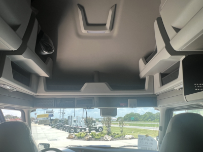 Volvo VNL64T660 truck cab interior view with overhead storage compartments and windshield, showing forward cab area.