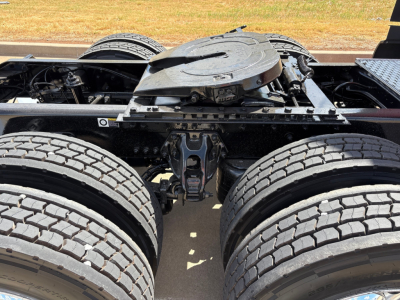 Kenworth T680 chassis with dual rear axles and fifth wheel, view of drivetrain and tires.