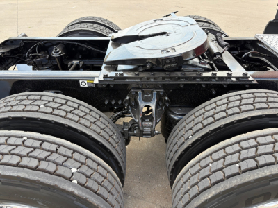 Kenworth T680 tractor rear chassis and fifth wheel area showing dual rear axles and suspension components.