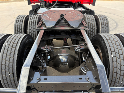 Kenworth T680 rear chassis showing dual rear axles and drivetrain components with fifth-wheel plate and suspension undercarriage.