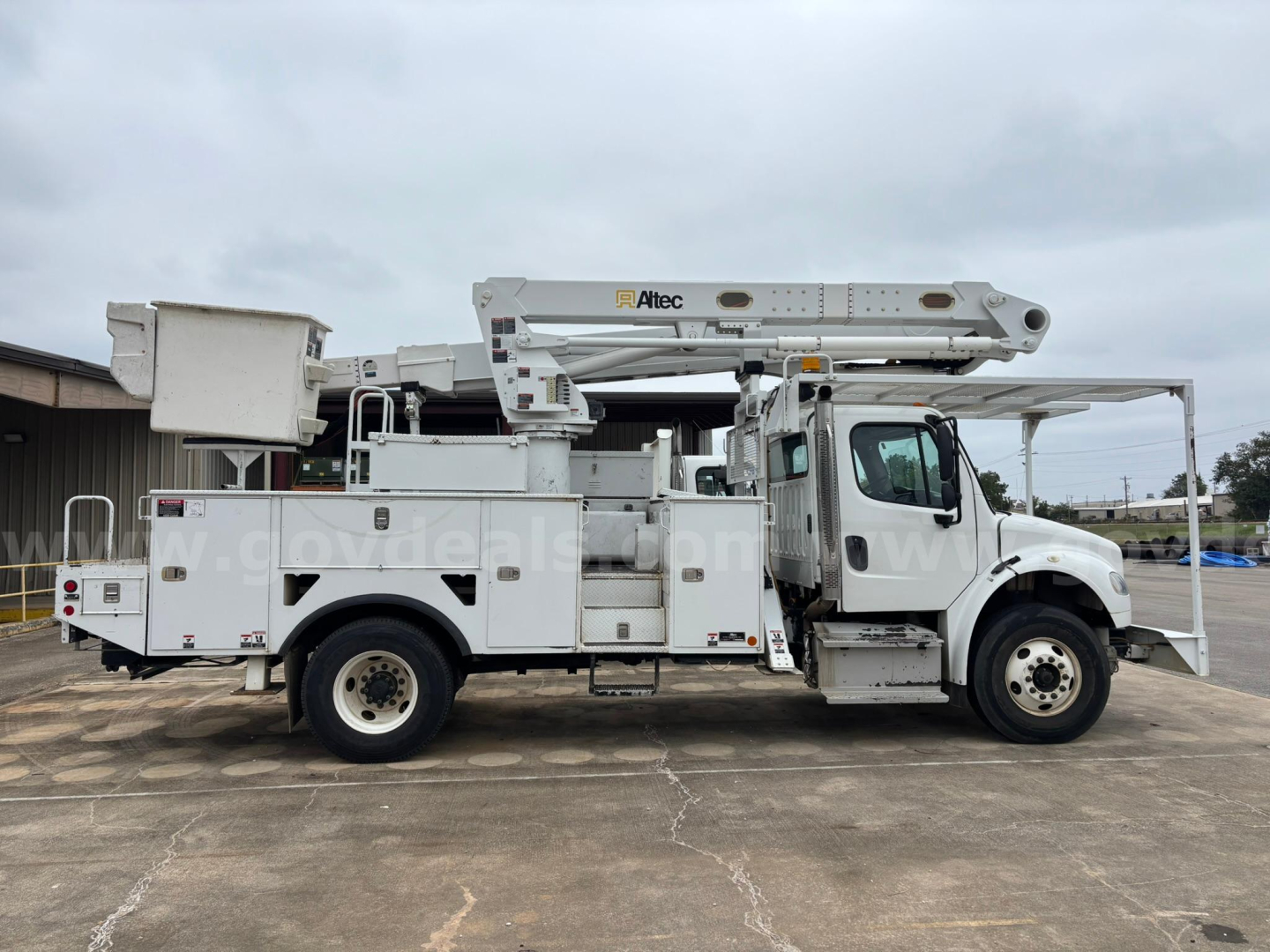 Truck bucket lift platform on Freightliner M2 106 in-service showing Altec boom and utility body with compartments