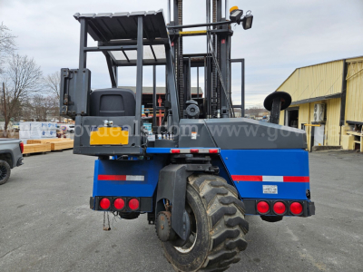Rear view of a 2005 Mack CV713 Granite forklift/utility vehicle showing blue body, large off-road tires, rear lights, and operator seat. VIN label and stock number not visible.