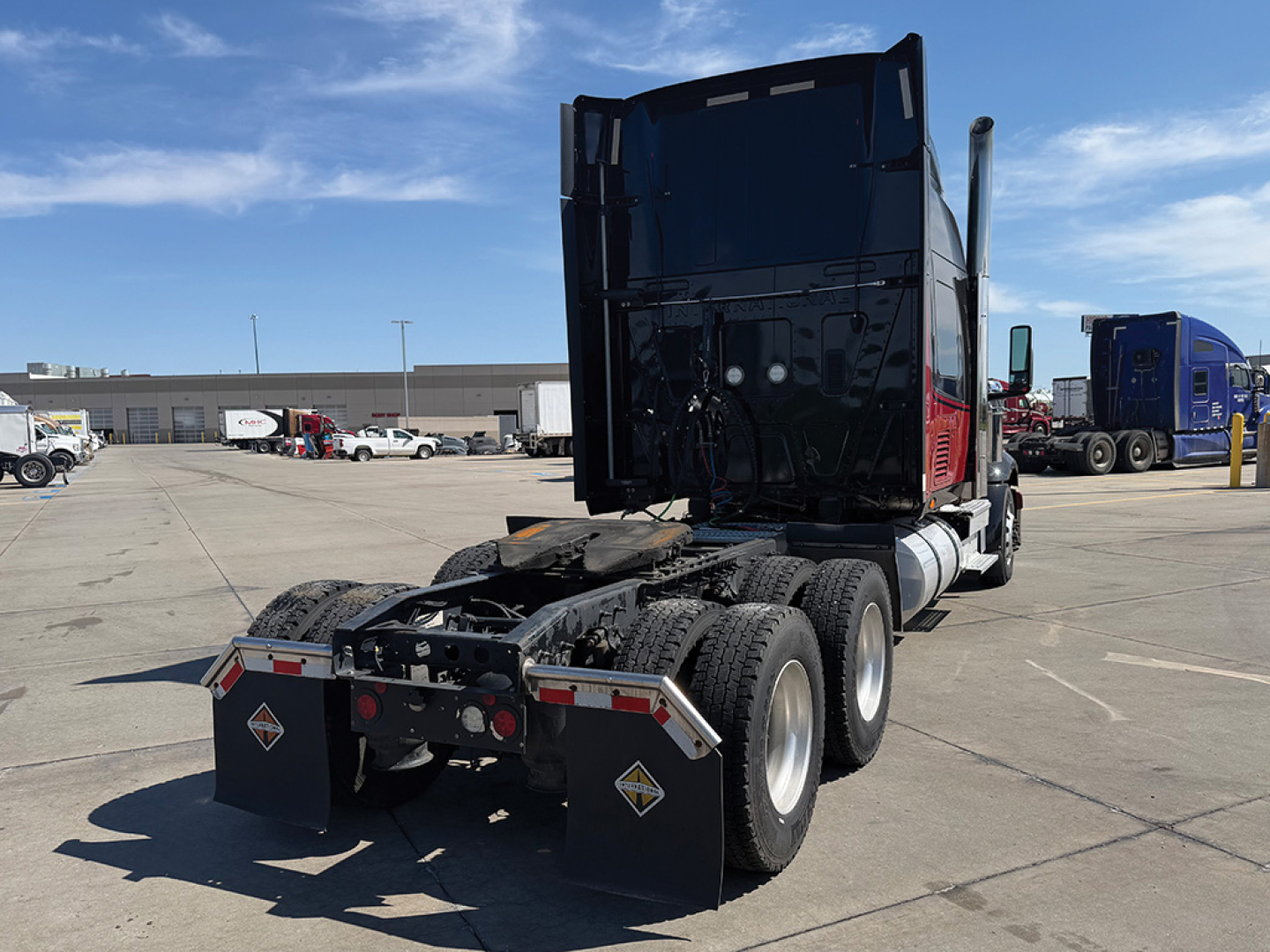 2021 International LoneStar tractor in a truck lot showing rear view with dual rear axles, fifth wheel, and mud flaps.