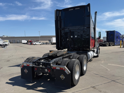 2021 International LoneStar tractor in a truck lot showing rear view with dual rear axles, fifth wheel, and mud flaps.