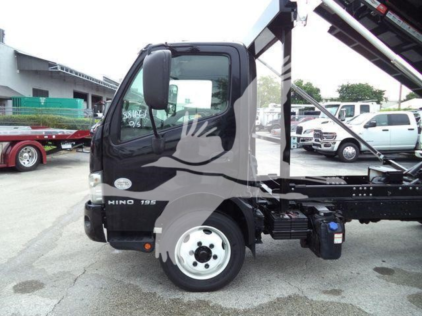 2019 Hino 195 roll-off truck cab side view with HINO badge and 195 model badge visible.