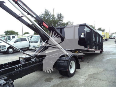 2019 Hino 195 roll-off truck showing rear of tractor and container with hydraulic arms and crane mechanism.