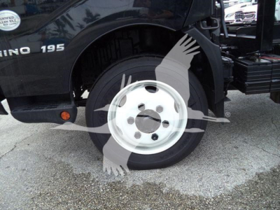 Front left wheel of a 2019 Hino 195 roll-off truck showing wheel and fender area with 'HINO 195' badge visible.