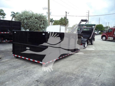 2019 Hino 195 roll-off truck with a large black dump body in a dealership lot; no visible branding text on the body from this view.