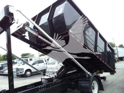 Rolloff truck bed on a 2019 Hino 195 with hydraulic lift assisting a tipped dump; side view shows black cargo box and supporting hydraulic arms.