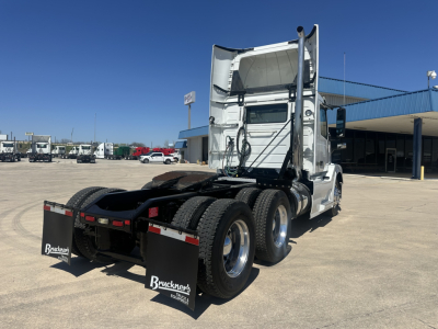 Volvo VNL64T300 truck tractor from rear three-quarter view showing dual rear wheels and mud flaps with Bruckners logos.