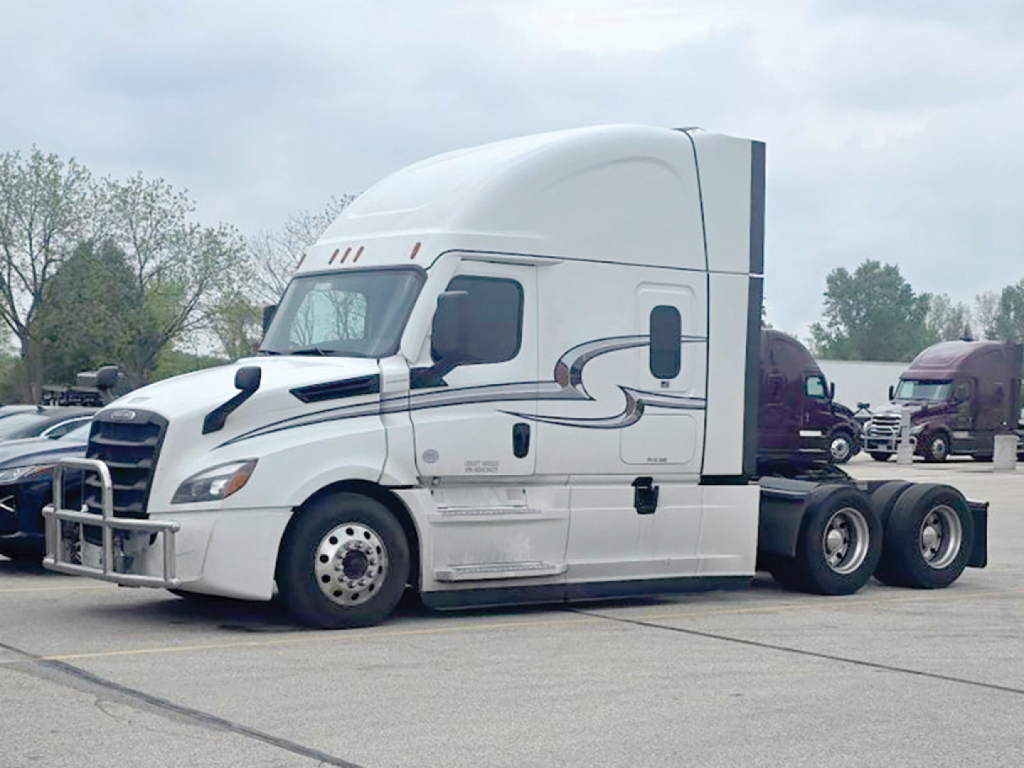 Truck showing Freightliner Cascadia125/126 sleeper cab with aerodynamic white exterior and chrome bumper; side graphics and side mirrors visible.