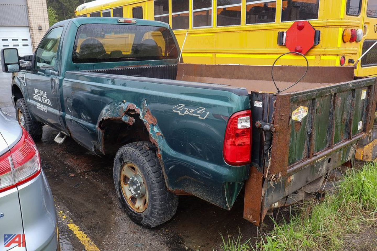 Ford F-250 pickup truck with plow and damaged rear quarter panel on the driver side in a parking lot.