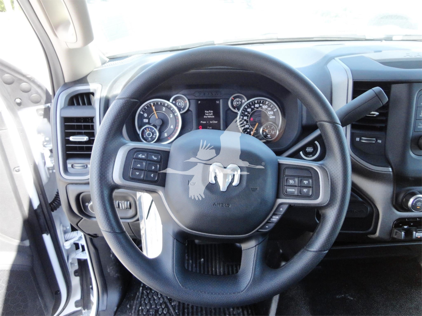 Ram 1500/Dodge Ram steering wheel with dashboard gauges visible in a pickup truck interior