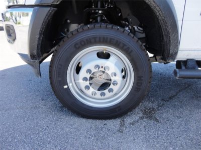 Truck front wheel and fender of a 2023 Ram 5500 HD hooklift truck showing Continental HD tire and wheel assembly.