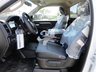 Ram 5500 Hd truck interior showing front seats with plastic protection and dashboard view.