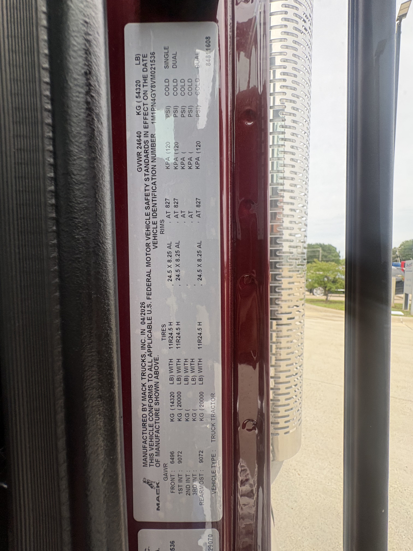 Vehicle door placard showing axle and gross weight ratings data for a Mack PI64T truck. Includes compliance and tire/wheel information and VIN-like label.