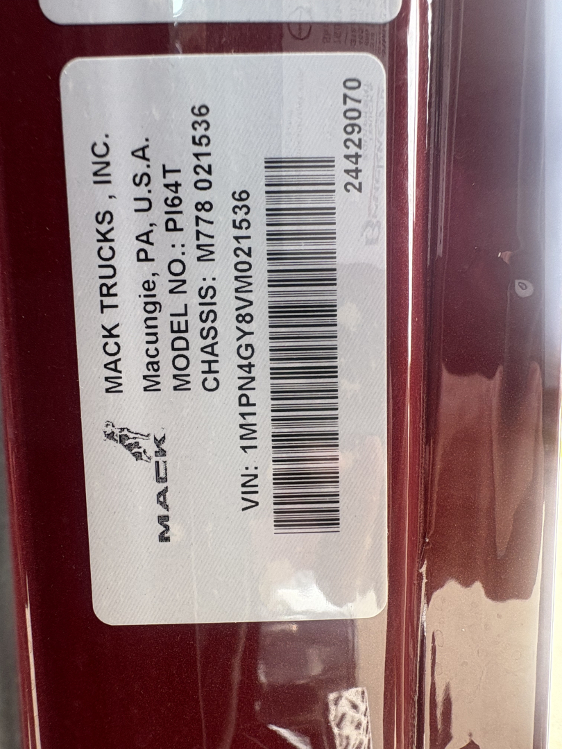 Mack Trucks VIN barcode label with tire and sticker details. Text includes: MACK TRUCKS, INC., Macung, PA U.S.A., MODEL NO. P64.136? CHASSIS: M7?; VIN: 1M1PN4GY8VM021536; STOCK: 72966; 24? and bar code. SIDE image shows a white sticker with