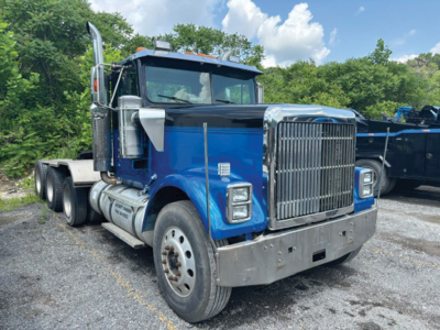 Truck cab showing front grille and blue body in a used 1998 International 9300 conventional daycab.