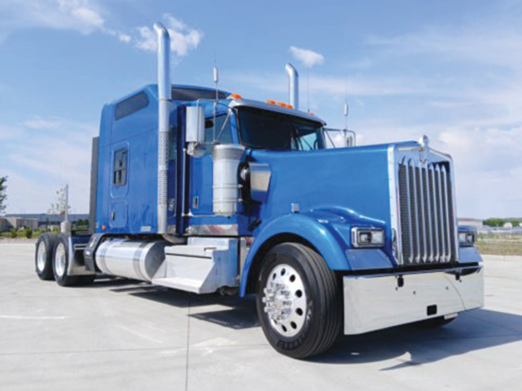 Truck image showing a blue 2019 Kenworth W-900L AeroCab Conventional Sleeper with chrome grille, dual exhaust stacks, and polished fuel tanks.