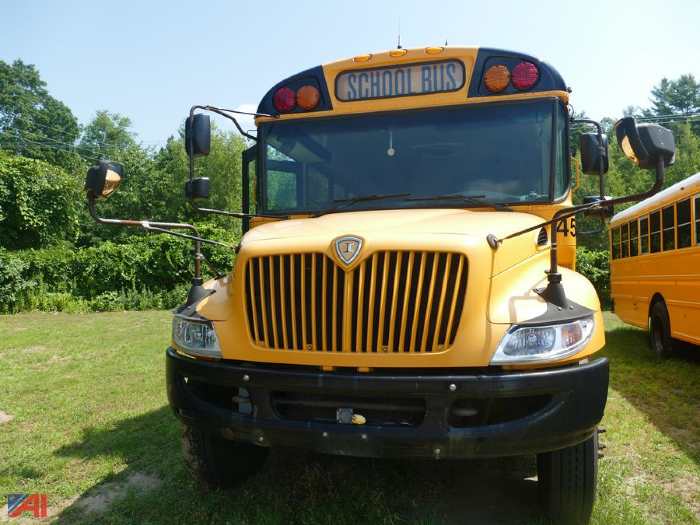 School bus front view showing yellow 2019 International CE 3000 with 'SCHOOL BUS' sign, grille, headlights, and bumper.