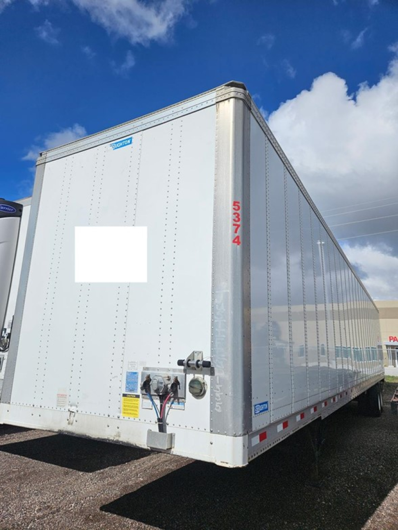 Trailers: Stoughton air ride dry van trailer with reflective aluminum walls, rear doors and red vertical numbers 5374.