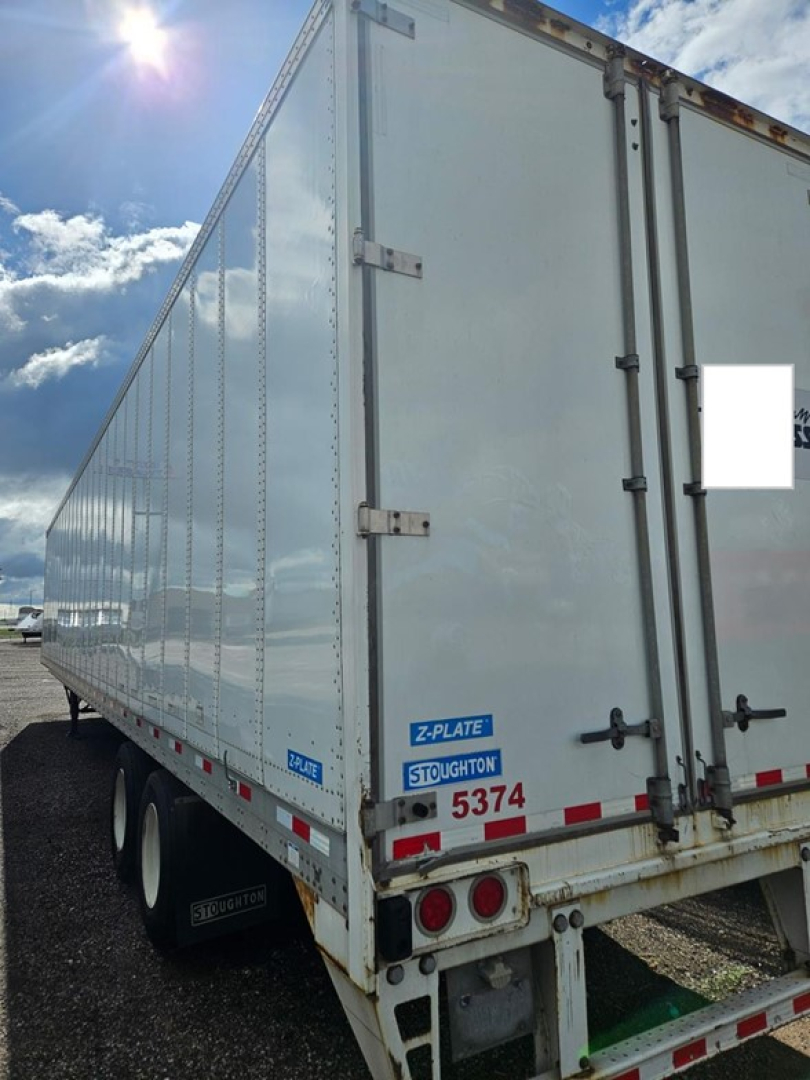 Stoughton air ride dry van trailer rear and side view showing doors, taillights, and valve area with blue Stoughton plate and stock number 5374.
