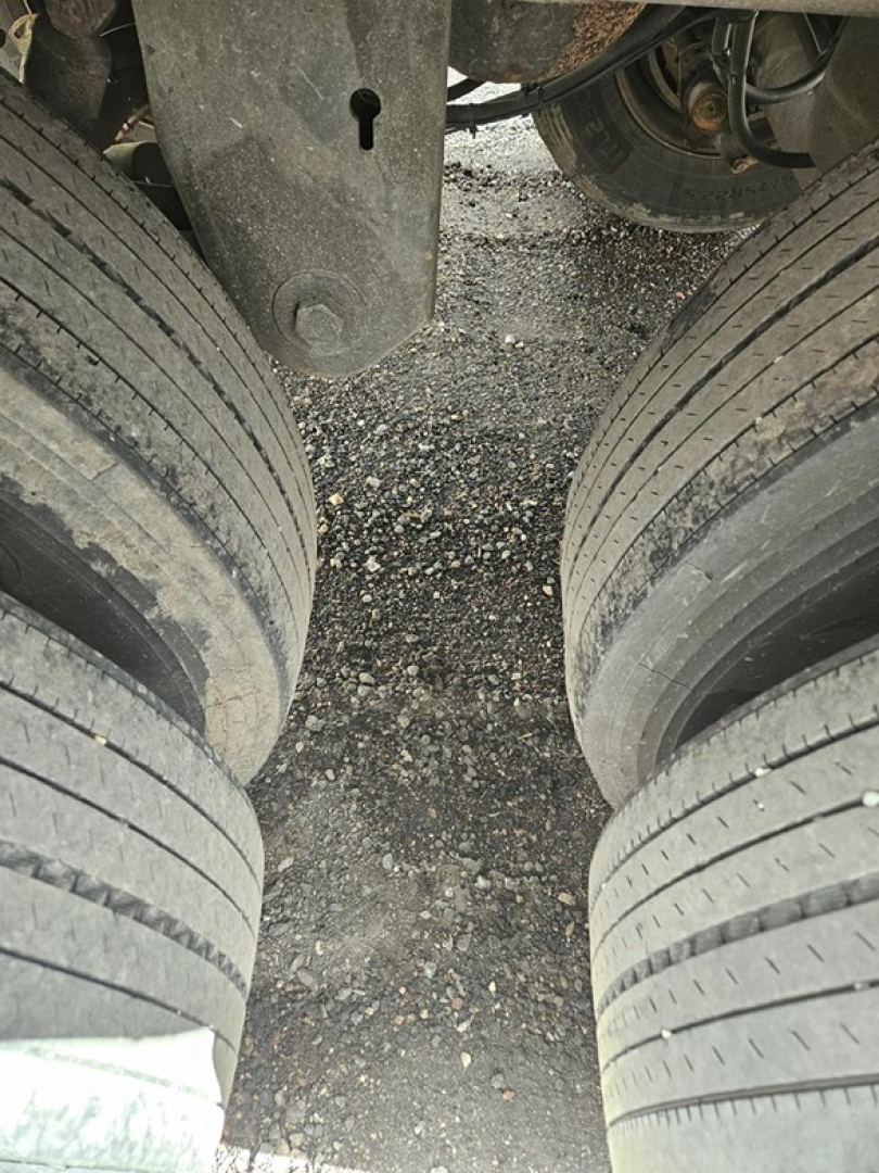 Trailer underside showing dual rear axle tires and suspension components of a Stoughton air ride dry van.