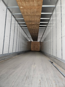 Trailer interior view of a 2018 Stoughton Air Ride Dry Van showing empty cargo area with wooden floor and sidewalls.