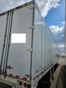 Stoughton air ride dry van trailer with rear doors and side panels visible, metal exterior, dual rear wheels.