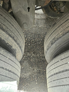 Trailer underside showing dual rear axle tires and suspension components of a Stoughton air ride dry van.