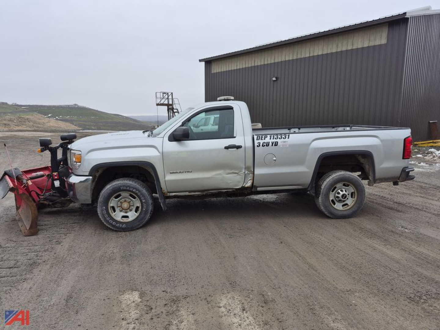 GMC Sierra 2500HD pickup with snow plow attached, side view showing cab and bed, light-colored vehicle with utility markings