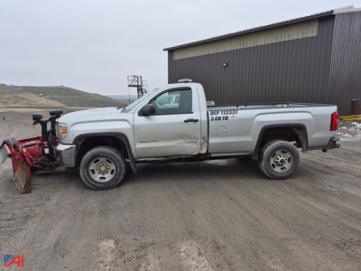 GMC Sierra 2500HD pickup with snow plow attached, side view showing cab and bed, light-colored vehicle with utility markings