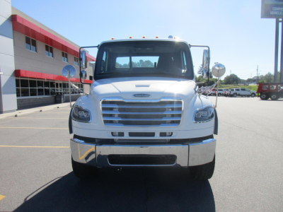 New Freightliner Business Class M2 106 Plus cab front view showing chrome grille and bumper with side mirrors.