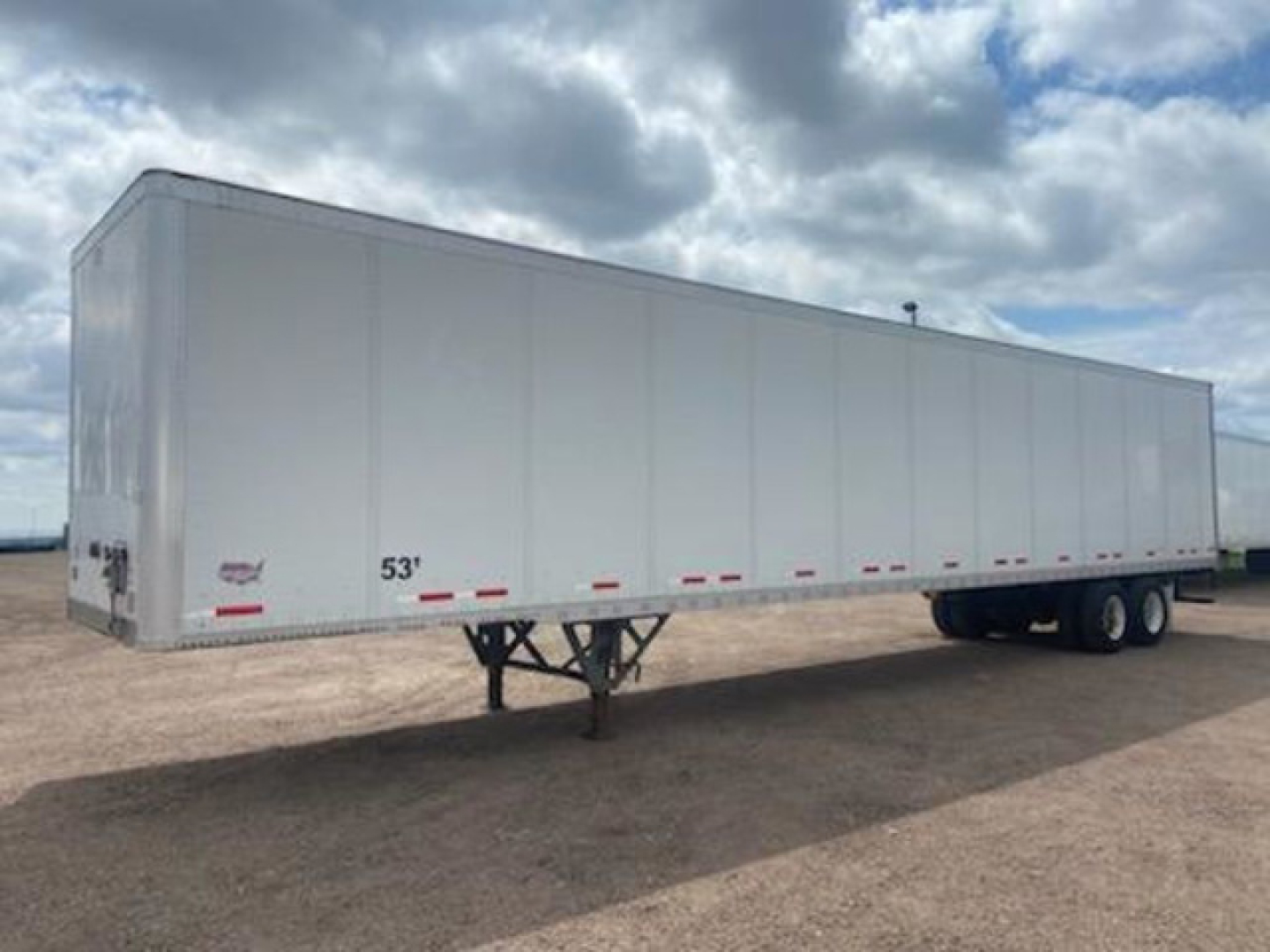 Trailer side view showing 53' Wabash van with tandem axles and front landing gear.