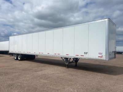 trailer axle area showing white enclosed trailer with tandem axle, 53' length, Wheeled landing gear visible, minimal markings: 53' label near front.
