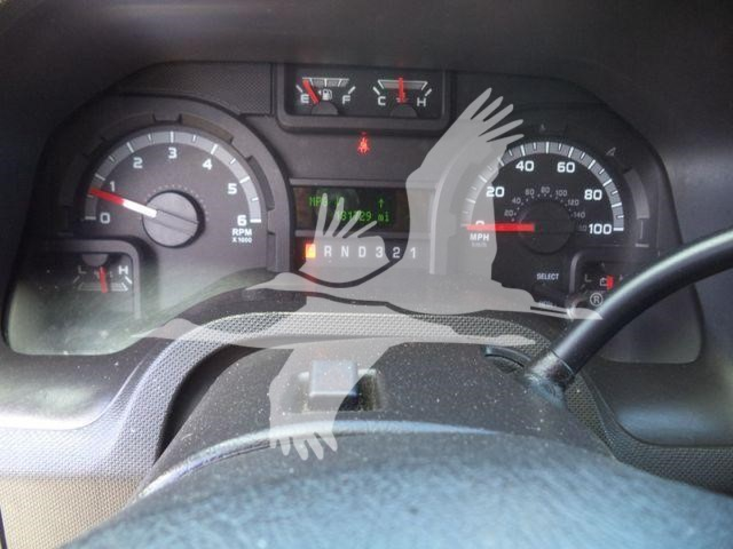 Dashboard view of 2011 Ford E450 instrument cluster showing speedometer, tachometer, and gear selector indicator.